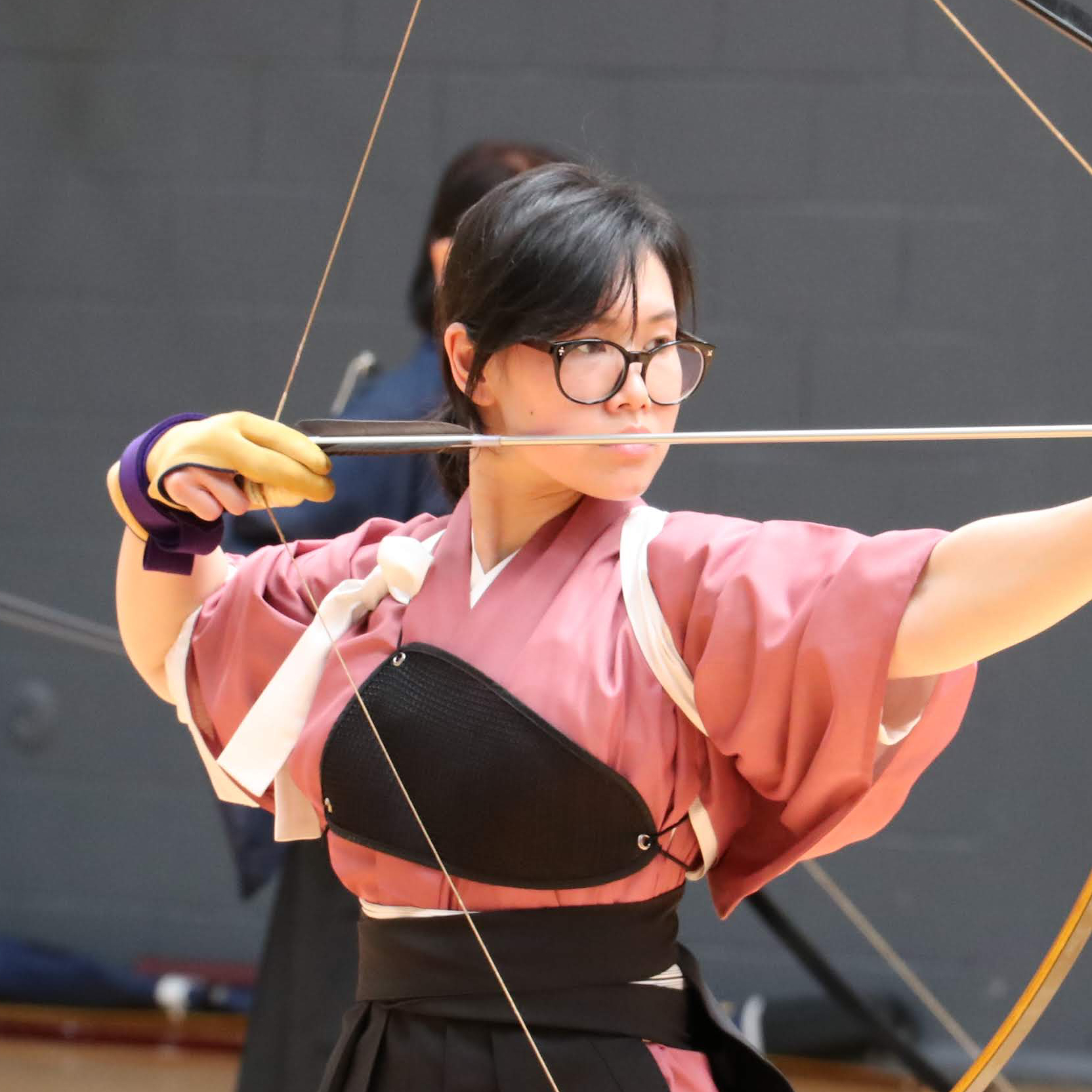 Photo of Prae doing Japanese archery, in full draw position